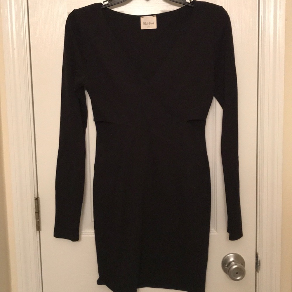 Long sleeve black bodycon dress with cutouts.